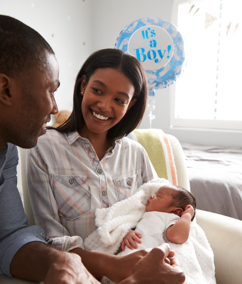 Parents Home from Hospital With Newborn Baby In Nursery